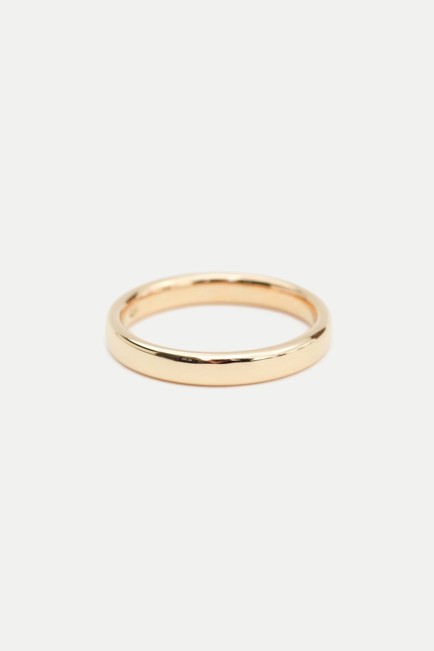 A simple 3mm gold band ring displayed on a white background.