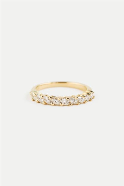 A gold half eternity ring with marquise diamonds set around the band.