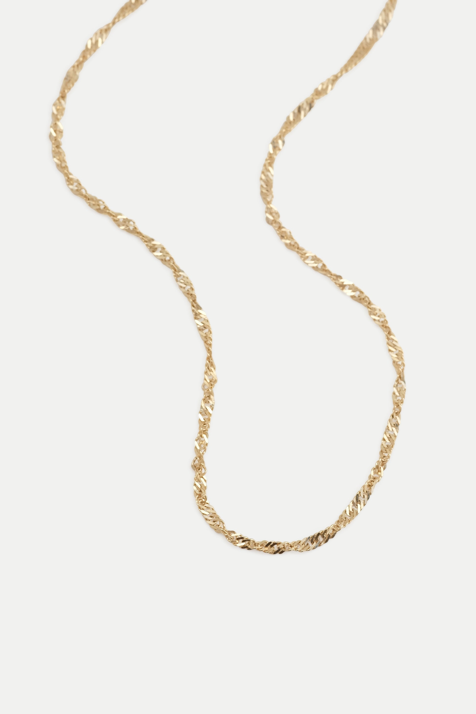Gold singapore chain displayed on a white background.