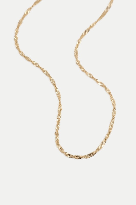 Gold singapore chain displayed on a white background.